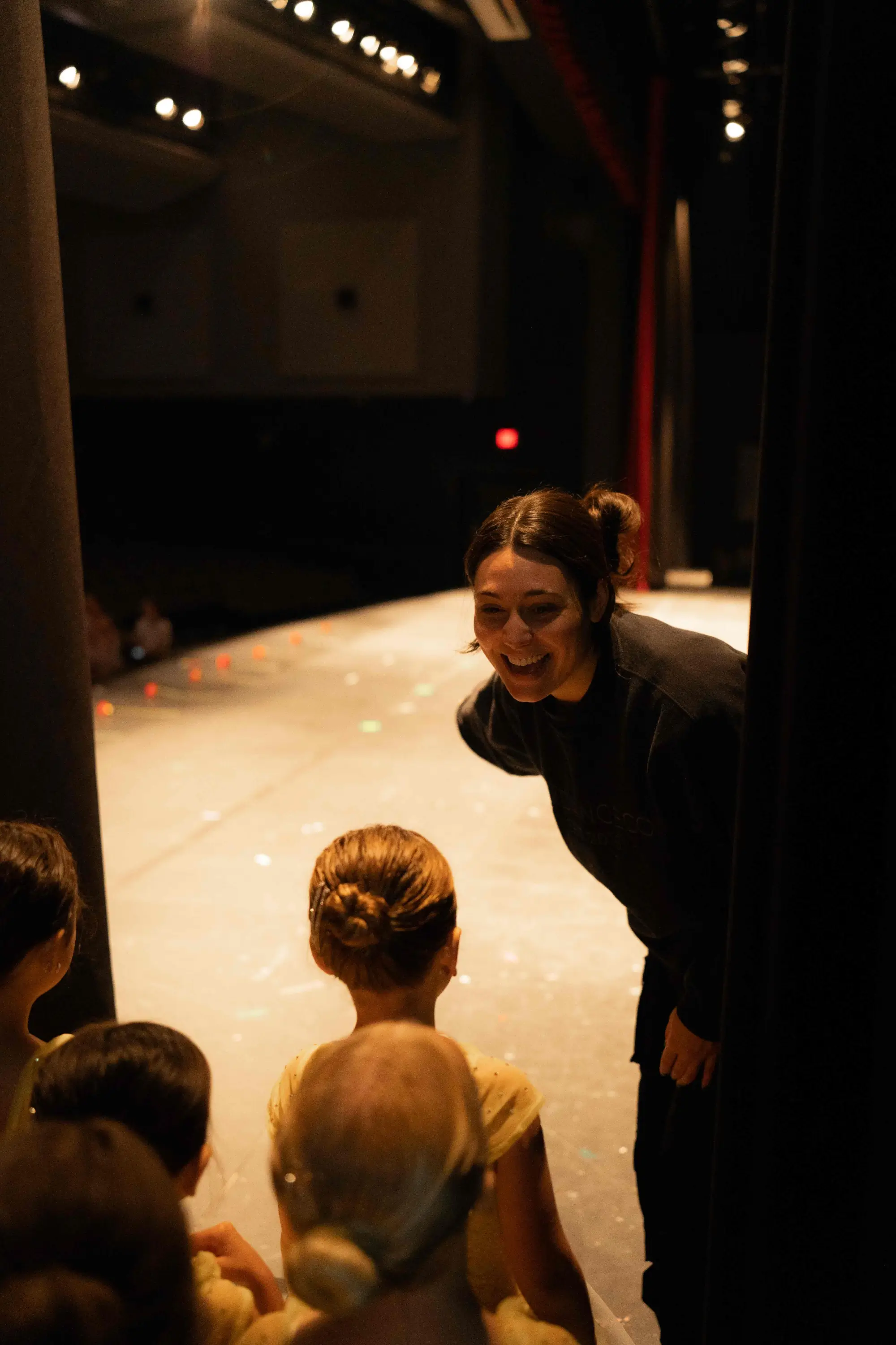 photo of young dance students receiving instruction from their teacher