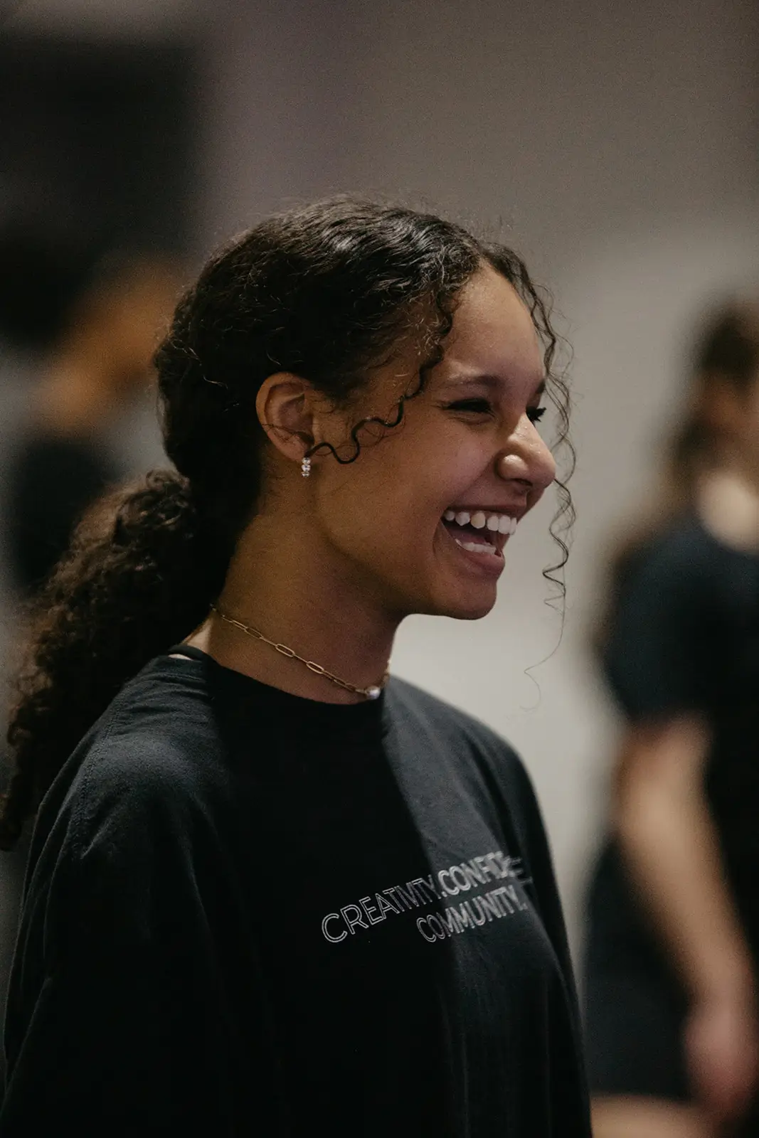 Woman smiling in a black shirt